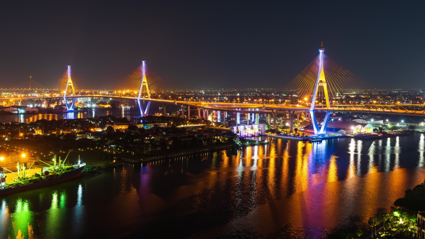 time lapse of Bhumibol suspension bridge cross over Chao Phraya River at night in Bangkok city, Thailand