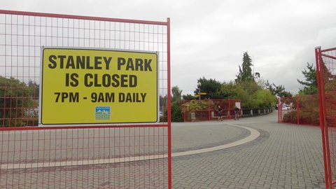 Vancouver, Canada - September 5,2021: View of sign Stanley Park is Closed from 7pm to 9am daily following attacks by coyotes in Stanley Park