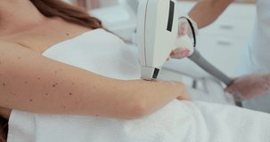 Close-up laser hair removal under the armpit of a beautiful girl in a beauty salon. Cosmetology and SPA concept.
