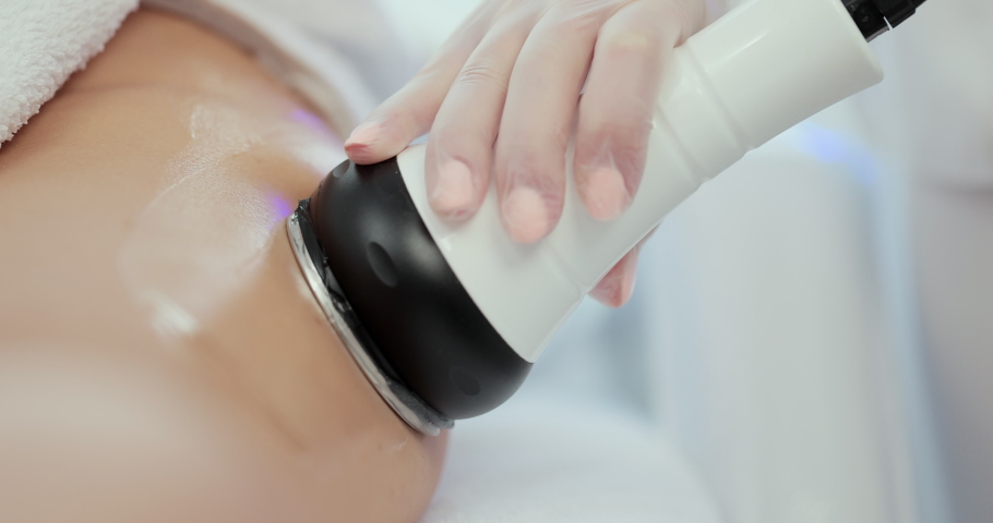 Close-up of the apparatus massages buttocks and hips of young female. Anti-cellulite machine cosmetology. Program for health and slimming. Hardware figure correction. | Shutterstock HD Video #1078826171