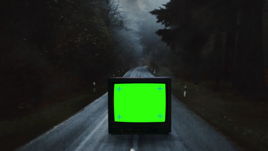 Old TV Green Screen On Spooky Dark Road, Vintage Television Traveling Shot. Vintage television with a green screen left on a spooky dark road. Traveling shot Royalty-Free Stock Footage #1078831475