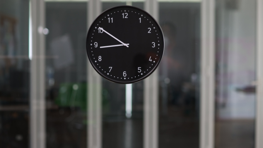 Time-lapse video 9AM-4.30PM office hours businesspeople does routine job in business time. Focus on watch moving from morning start to quit in afternoon shows company employees work in working room. Royalty-Free Stock Footage #1078833338