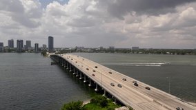 Bridge over water aerial 4k. Drone flying past Julia Tuttle Causeway in Miami FL