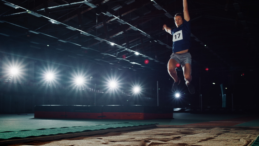 Long Jump Championship: Professional Male Athlete Running on Track and Distance Jumping. Determination, Motivation, Inspiration of Record Breaking Sportsman. Dramatic Light, Cinematic Slow Motion | Shutterstock HD Video #1078843343