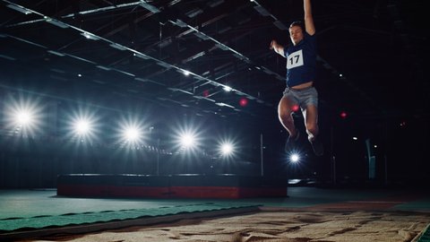 Long Jump Championship: Professional Male Athlete Running on Track and Distance Jumping. Determination, Motivation, Inspiration of Record Breaking Sportsman. Dramatic Light, Cinematic Slow Motion