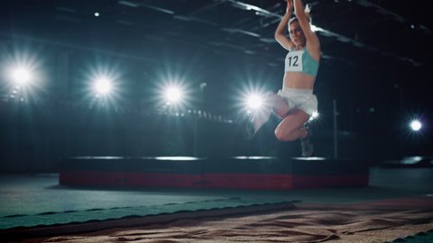 Long Jump Championship: Professional Female Athlete Running on Track and Distance Jumping. Determination, Motivation, Inspiration, Winning. Dramatic Light, Dolly Shot with Cinematic Slow Motion