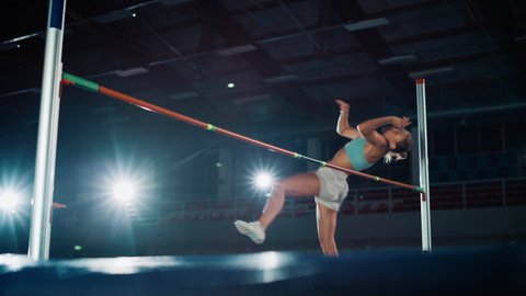 High Jump Championship Championship: Professional Female Athlete Running with Jumping over Bar. Determination, Endurance, Motivation, Effort of Champion in Training. Slow Motion Cinematic Shot
