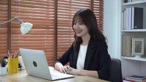 Asian businesswoman wearing braces gives presentations, talks, teach, learn, conference online with wireless laptop.