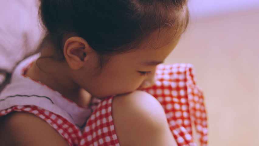 Face close up of adorable asian kid girl is lonely crying on the bedroom floor with despair, depressed, upset and sadness which is due to family or school punishment which is violence problem. | Shutterstock HD Video #1078846436