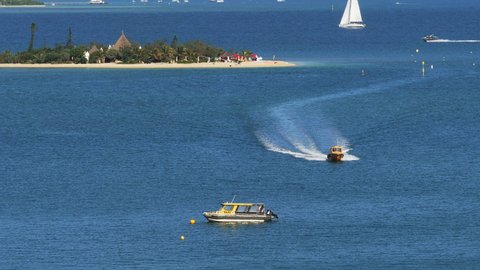 Water taxi carries tourists between Anse Vata Beach and Duck Island, New Caledonia.