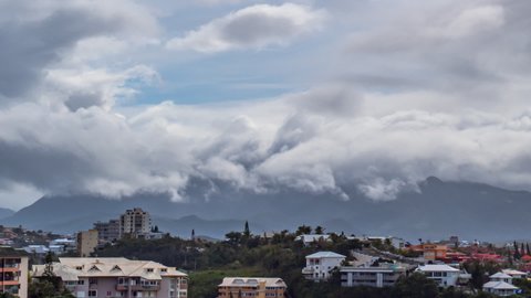 Low clouds seem to surf along mountain ridge above Noumea, New Caledonia.Timelapse