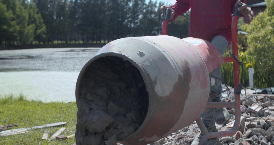 Men making cement in a hotel under construction - Empty hotel under construction - Dusty construction vibes - 4k Slow motion