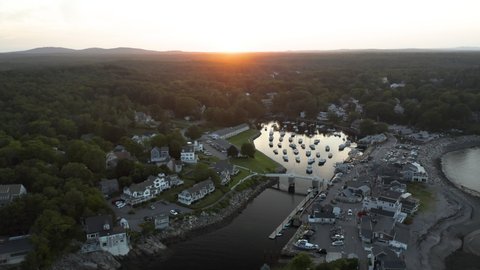 Aerial orbiting footage of Perkins Cove in Ogunquit, Maine at sunset