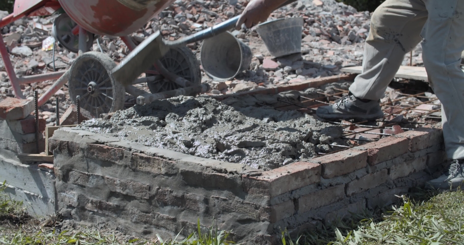 Men making cement in a hotel under construction - Empty hotel under construction - Dusty construction vibes - 4k Slow motion