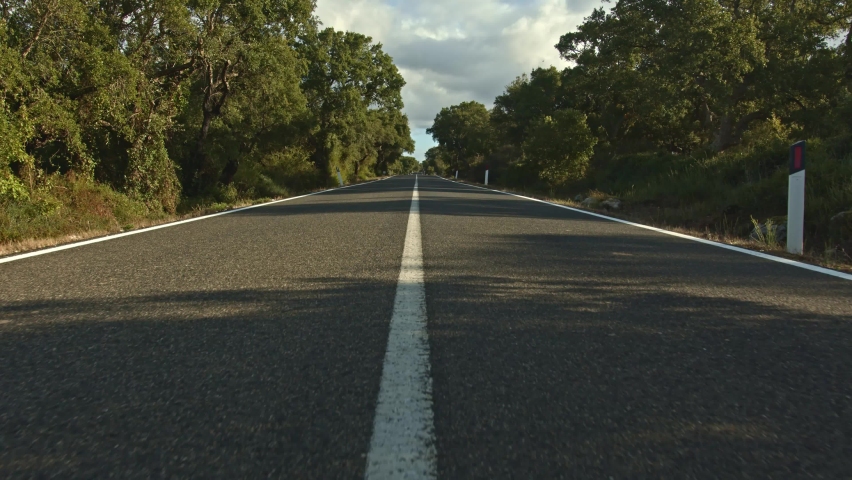 Wide angle shot of majestic endless country asphalt road, dolly forward view
