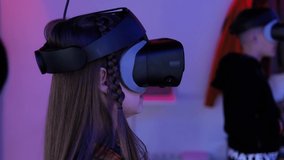Funny teen girl using virtual reality glasses play game, having fun, enjoying the 360 degree virtual environment. VR glasses cardboard. Modern technology. 3D gadget.