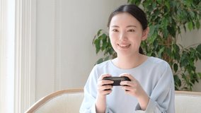 attractive asian woman playing video game