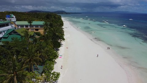 Aerial of Dumaluan beach with white sand and crystal blue water, turquoise water with tourists walking on the seashore, Bohol Island in thePhilippines, freedom and travel concept, summer vacations 