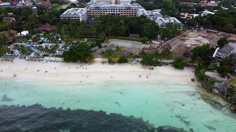 Aerial of sandy beach with green palm trees, turquoise water and tourists,Bohol Island in Philippines, Alona beach, summer and vacation concept, traveling, asia, trip, wild nature aerial, dream trip