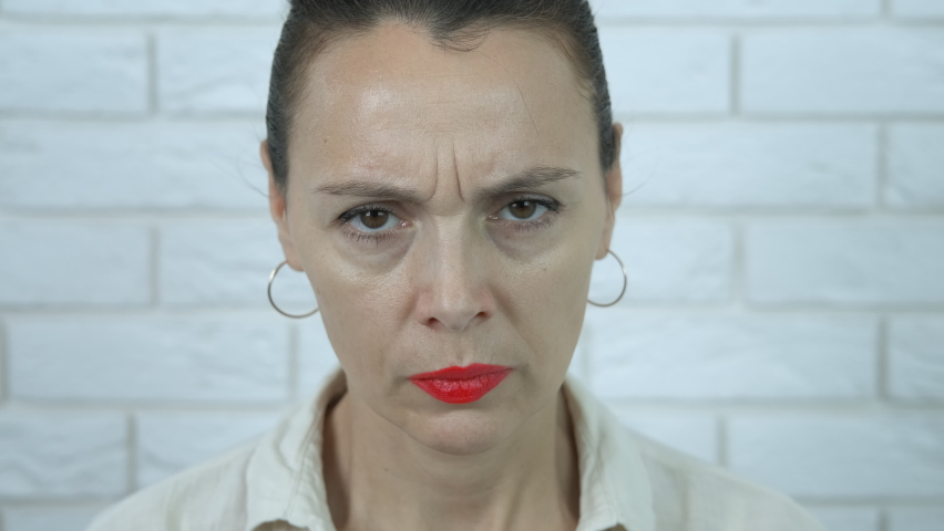 Feminist rights. A woman shows a drawn feminist logo on her hand.