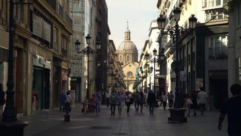 Zaragoza, Spain-29 May, 2021: People are strolling through Alfonso I street with view of the Cathedral Basilica of Our Lady of the Pillar at Zaragoza city. A Roman Catholic church of Spain.-Dan