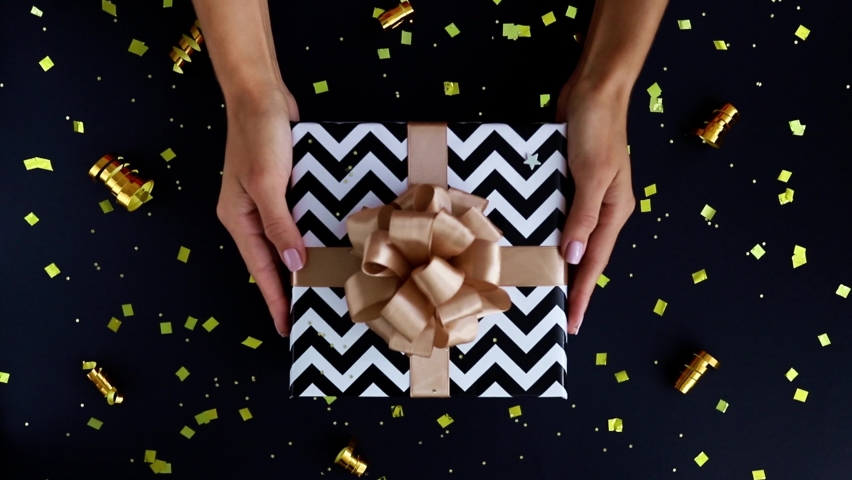 Hands put the gift box on the table