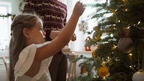 Girl with daddy decorating the Christmas tree. Shot with RED helium camera in 8K  - Powered by Shutterstock - Get 15% off with code: PIKWIZARD15