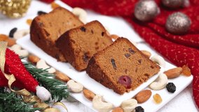 Indian Christmas celebration 4K slow motion video , footage. Woman serving homemade Christmas plum cake India Kerala. Fruitcake of dried fruit, nuts, spices , rum New Year party, Easter, Christmas Eve