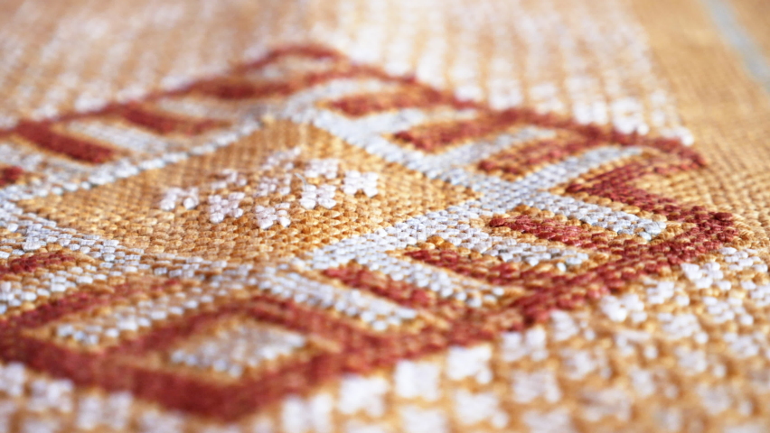 Detail of a handmade, traditional, Moroccan cactus silk (Sabra silk) rug, carpet. Macro closeup abstract geometric patterns, handwoven, shallow depth of field. Royalty-Free Stock Footage #1078894247