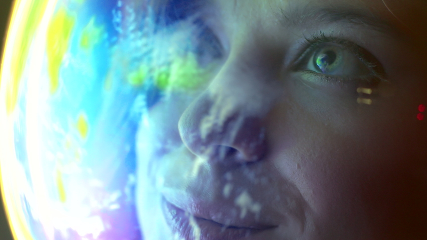 Portrait of happy woman astronaut wearing helmet looking at earth globe in outer space closeup. Sci-fi world expedition, global flight in amazing cosmos, spacewalk, planet exploration by brave human Royalty-Free Stock Footage #1078902434