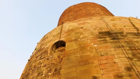 The Historical Ancient Ruins of Dhamek Stupa with Floral Carvings in Sarnath, Varanasi, India. Close Up Shot with Smooth Pan