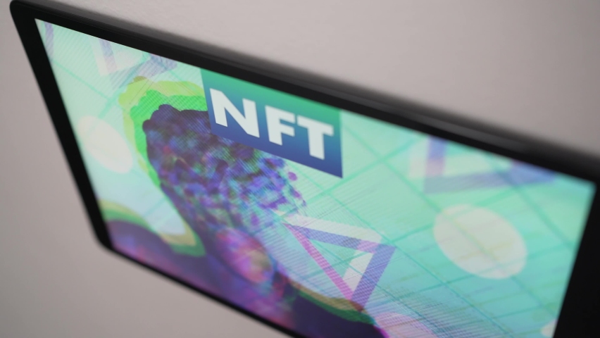 On a wall mounted screen, an animated NFT Non-fungible token being on display Royalty-Free Stock Footage #1078918256