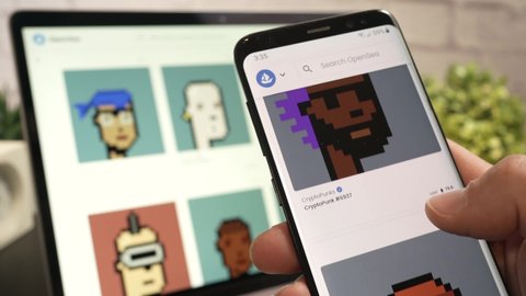 Online NFT marketplace selling Non-fungible token on a laptop computer and smartphone. CryptoPunks NFT for same on a website MONTREAL CANADA SEPTEMBER 2021