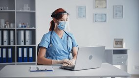 online doctor consultation, female veterinarian in medical mask on her face communicates via video link with patient sitting in hospital office