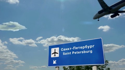 Jet plane landing in Saint Petersburg, Russia. City arrival with airport direction sign. Travel, business, tourism and transport concept.