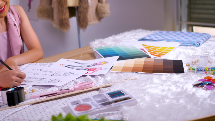 Fashion designer stylish woman working on her sketch designs in the studio. 4K | Shutterstock HD Video #1078942775