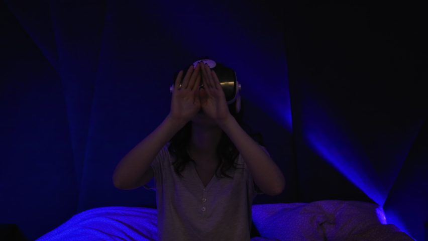 Woman Using Virtual Reality Headset Sitting on The Bed Looking Around. Future VR Education Technology And New Technologies Diversity Concept VR Futuristic Royalty-Free Stock Footage #1078945229