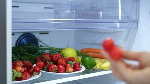 Kid Eating Cherries from Fridge, Hungry Child Eats Fresh Fruits in Refrigerator, Young Girl at Diet, Healthy Food Woman in Kitchen