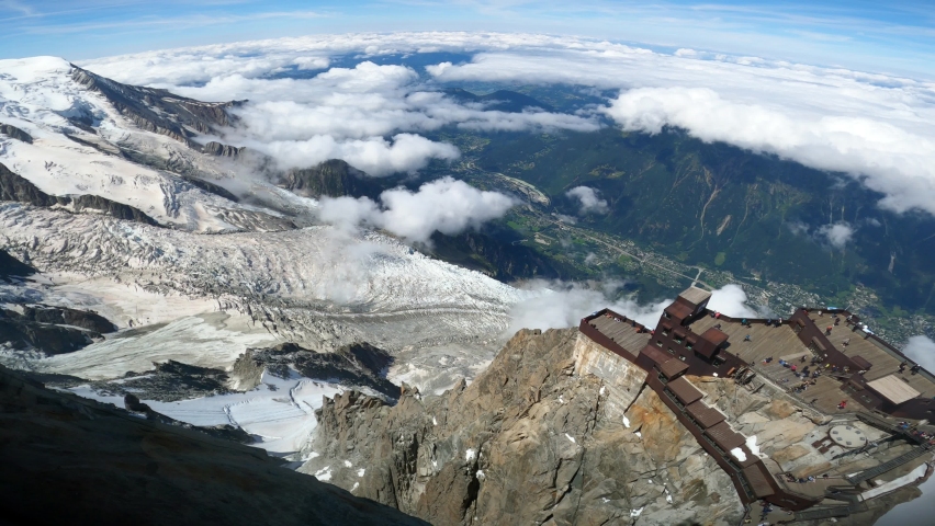 Alpinists reaching top of Aiguille du midi, chamonix, in Swiss Alps. Sport at the snowy mountains in Europe. 