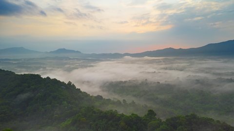Hyper lapse by Drone, Beautiful Landscape in the morning time 
 during sunrise with fog above the mountain, White fluffy clouds moving softly on cloudy, Pang puai Mae moh Lampang, Thailand.
