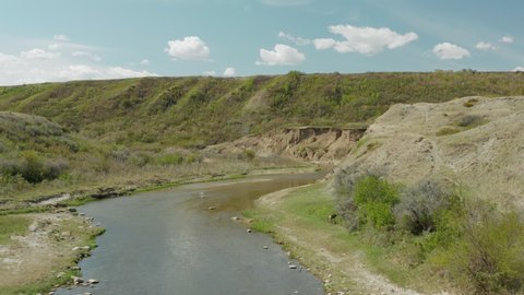 Aerial above tranquil stream of fresh water, river in Saskatchewan, Canada