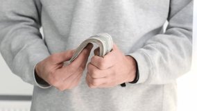 Closeup of female hands counting dollar bills