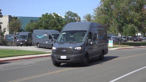 Amazon Prime delivery vans pulling out onto street to go on delivery. Video taken in Carlsbad, CA USA on September 10, 2021