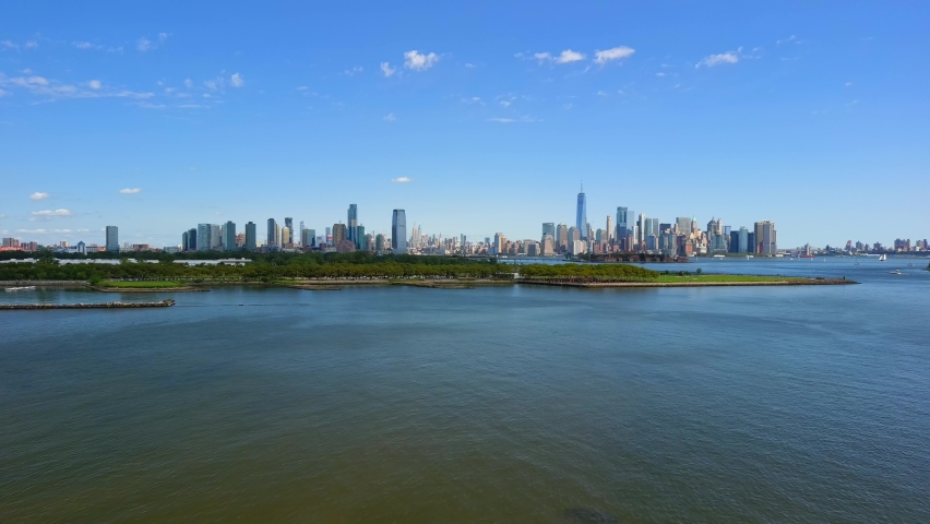 This video shows gorgeous aerial views of Jersey City and New York City Skyline over the Hudson River.  Royalty-Free Stock Footage #1078972079