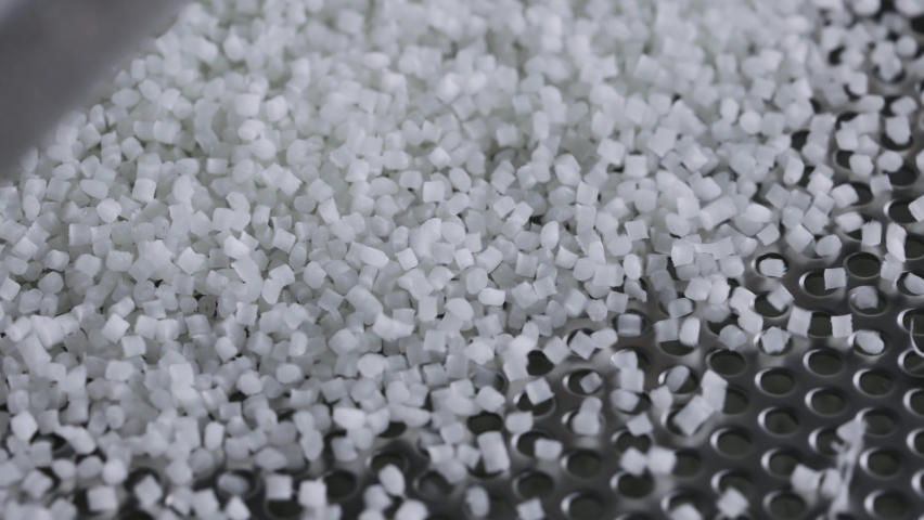 Plastic granules on a vibrating table. Polymer compound production Royalty-Free Stock Footage #1078985036