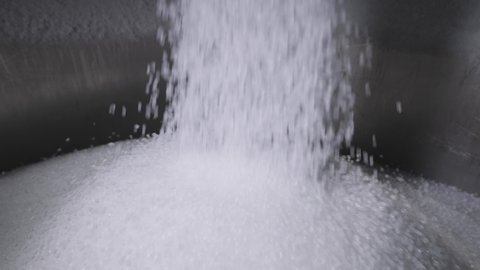 The plastic granules are poured into a large tank. Production of polymer compounds.