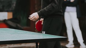Table tennis game serve concept. slow motion video. blurred focus on the grid. man playing training serve ball in table tennis the sport active lifestyle