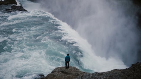 beautiful landscape of gullfoss waterfall back view of man standing 