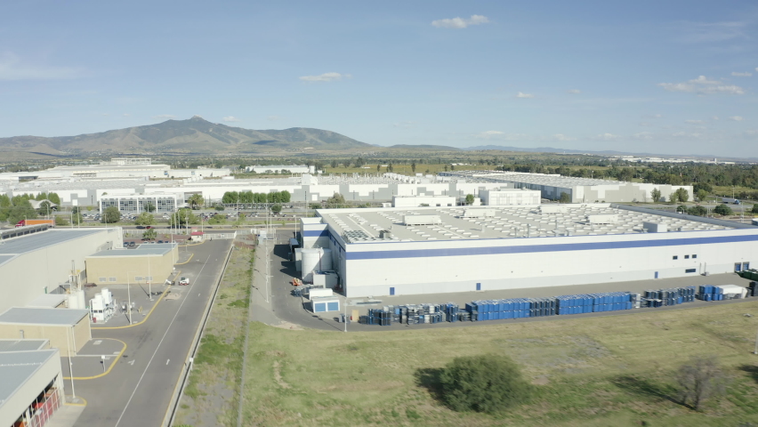 air tour over a huge industrial park full of warehouses of international companies on the outskirts of Leon in Guanajuato Royalty-Free Stock Footage #1078992509