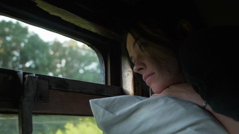 Woman Travel by Old Vintage Train Third 3rd Class Platzkart Car. Female Tourist Lying on Top Bunk Bed Shelf Looking at Window Watching Nature. 2x Slow motion 60fps 4K